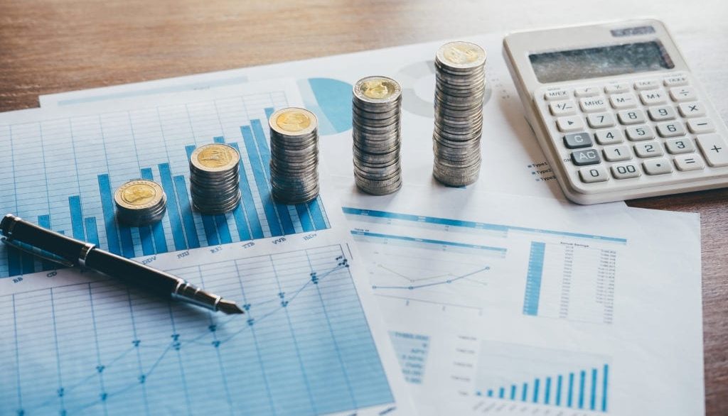 spreadsheet with stacks of coins and a calculator